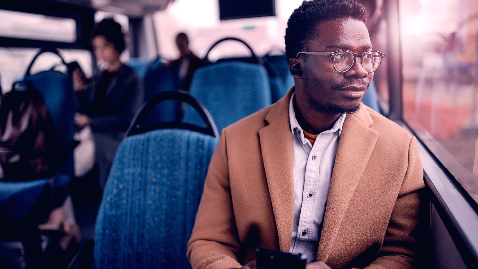 ~ai-c3184031-2b89-4269-aab9-119be7773ce8_ Man looking out a window sitting on a bus