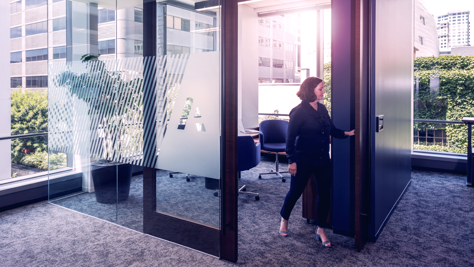 ~ai-c3184031-2b89-4269-aab9-119be7773ce8_ Woman walking out of an office