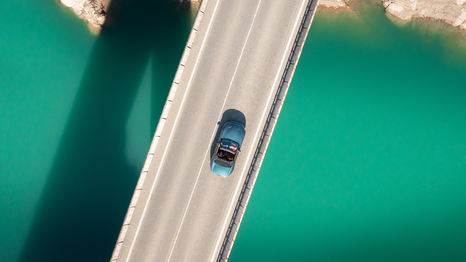 JLR Customer Story Illustrative image 2 Aerial shot of a car driving over a bridge
