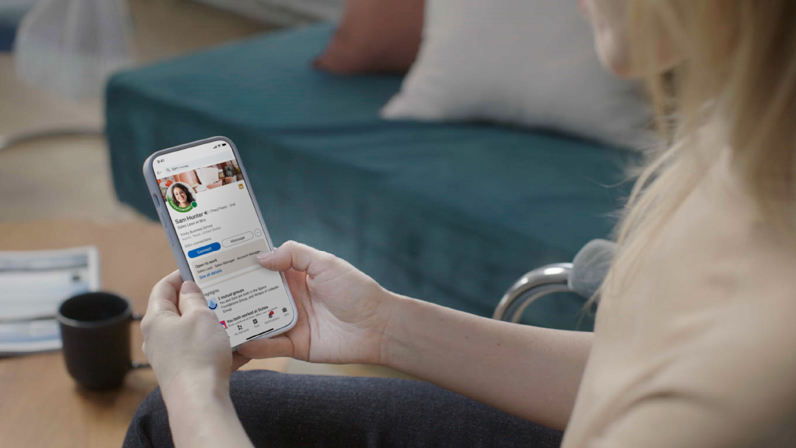 resources_customerStory_linkedIn Image of woman looking at a LinkedIn profile on her smartphone