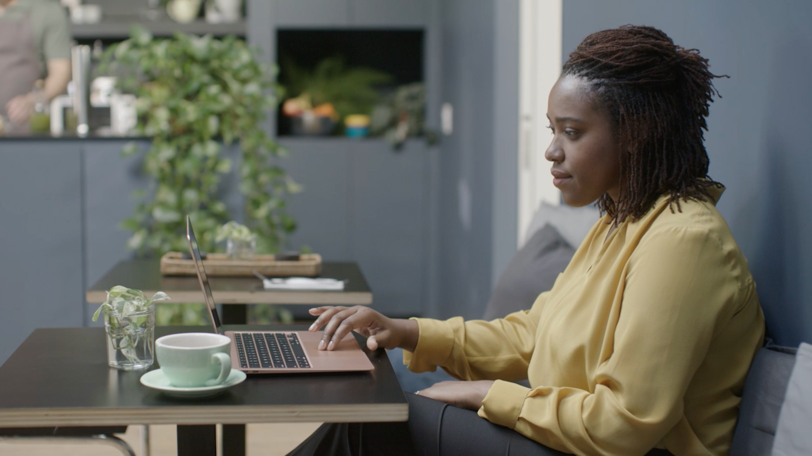 resources_customerStory_linkedIn Image of a woman sitting at a desk working on a laptop