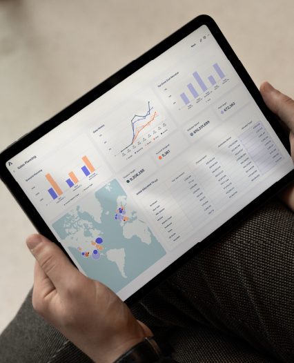 Sales Marketing Solutions Overview Page An individual engaged with a laptop, which features a graph, suggesting research or solutions tracking.